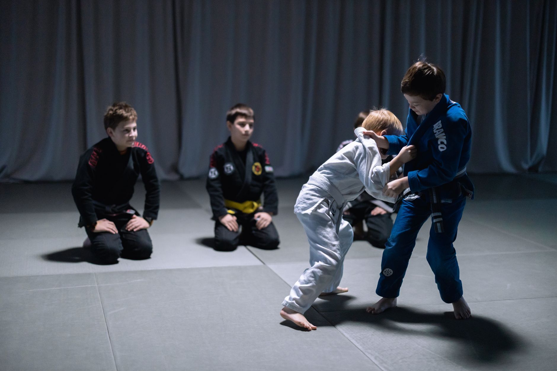 Kids practicing in Gi showing Brazilian Jiu-Jitsu youth belts during class