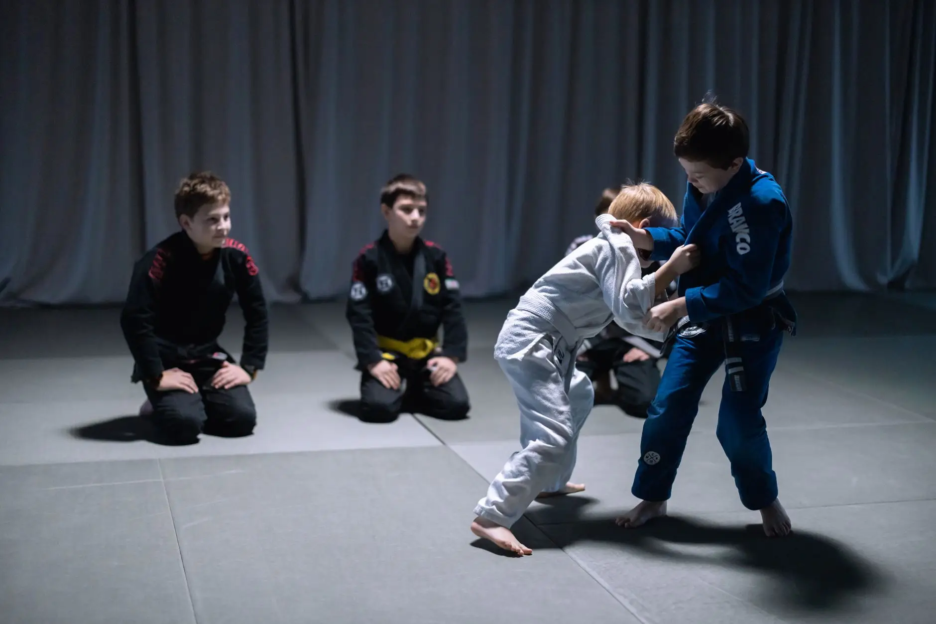 Kids practicing in Gi showing Brazilian Jiu-Jitsu youth belts during class